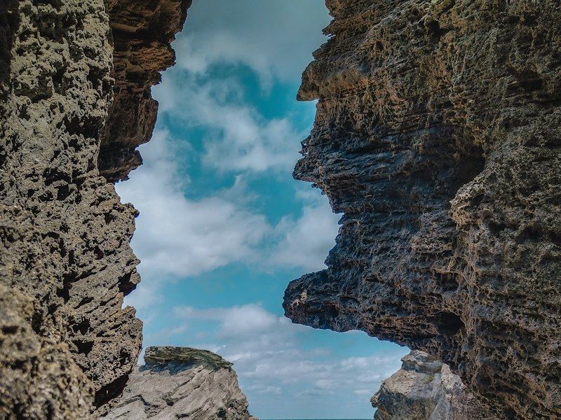 A sea view through a limestone rock arch in Bermuda